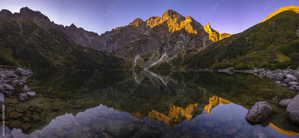 Panorama of a mountain lake during sunrise - Morskie Oko, Tatra Mountains, Poland - obrazy, fototapety, plakaty 