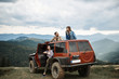 © Yakobchuk Olena - Enthusiastic young friends sitting in the off-road car while having an exiting tour in the Carpathian mountains