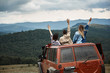 © Yakobchuk Olena - Rear view of an active travelers sitting in the off-road car and travelling in the mountains during their weekend