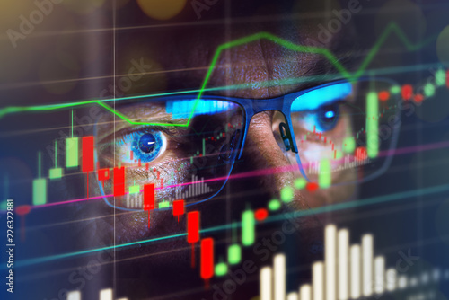 Cuadros en Lienzo Close up of stock market trader looking at graph