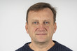 © OlegD - Portrait of a middle-aged man against a white wall background