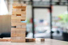 Wooden Block Tower On Office Background. Business Planning, Risk Management, Solution And Strategy Concepts