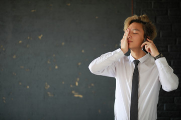 Wall Mural - Young Asian businessman in white shirt and tie