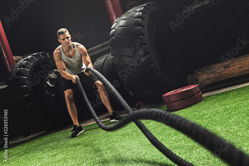 Fotografía Man is making battle rope exercises during his cross training workout