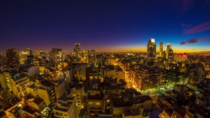 Wall Mural - Time-lapse view on the skyline of the city as colorful clouds pass by in the light of the setting sun in Buenos Aires, Argentina.
