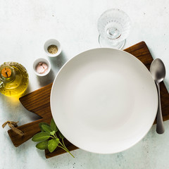 table setting. empty plates, spices, cutlery and olive oil. place to write text. copy space. collage template