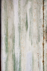 Green white paint on wooden plank or fence.