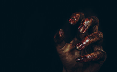 Bloody dirty zombie hand on black background. Halloween spooky poster