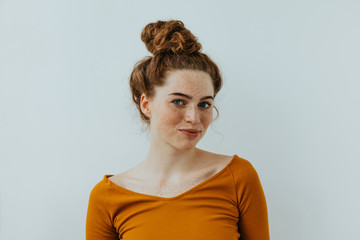 woman portrait. style. beautiful blue eyed girl with freckles is looking at camera and smiling, on a
