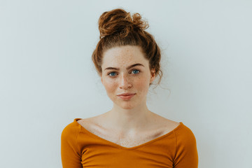 woman portrait. style. beautiful blue eyed girl with freckles is looking at camera and smiling, on a
