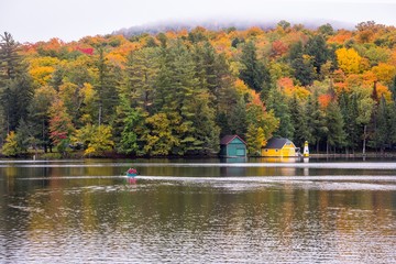 Wall Mural - Kayakers on a lake with fall color in New England