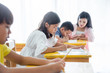 © gamelover - Asian elementary school student doing their homework at school classroom.