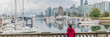 © Maridav - Vancouver woman at city skyline wearing helmet biking in harbour front of urban background panorama banner.