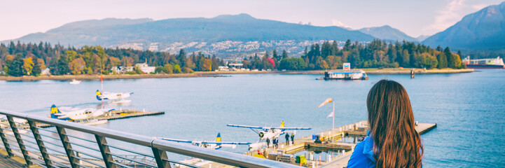 Wall Mural - Woman walking in Coal Harbour in Vancouver city in fall, BC, Canada. Autumn travel lifestyle panorama banner.