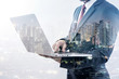 © totojang1977 - Double exposure of businessman using laptop with city night background, business concept.