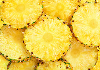 Wall Mural - top view of sliced pineapple fruit as textured background