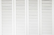 © FotoHelin - Plantation style white window sun shutters. Background concept.