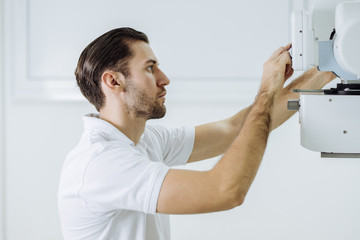 Wall Mural - Medical Technician Operating an X-ray Machine