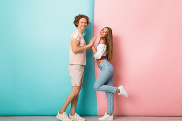 Wall Mural - Full length of smiling young couple