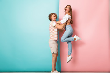 Wall Mural - Full length of smiling young couple