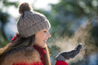 Fresh breath in frozen winter day of young happy woman