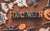 Fototapeta Panele - Fresh delicious homemade decorated halloween cookies sweets on dark wooden background, concept of halloween party, copy space(text space), top view, blank for text.