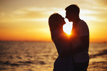 Wall Mural - Young happy couple on seashore.