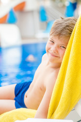 Wall Mural - Happy little boy by the pool.  Relaxation resting vacations concept