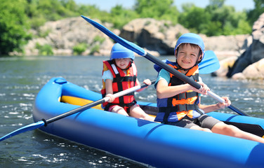 Wall Mural - little children kayaking on river. summer camp