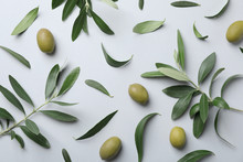 Flat Lay Composition With Fresh Green Olive Leaves, Twigs And Fruit On Light Background