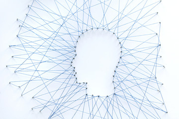 Sticker - Human head shape made from a large grid of pins connected with string. Communication technology and mental health concept