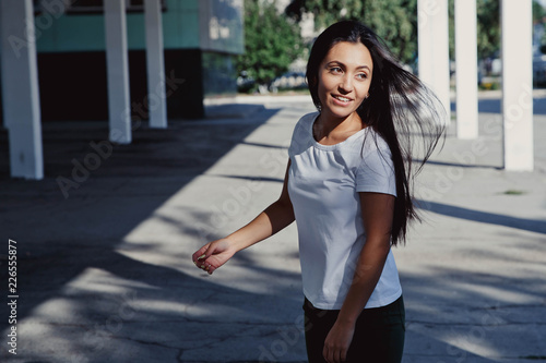 Young Beautiful Happy Girl With Long Black Hair Goes Against The