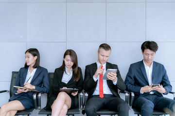 The applicant is sitting to prepare for an interview for a job in a public company in office