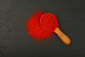 Wall Mural - Wooden scoop spoon full of red hot chili pepper