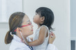 © reewungjunerr - Asian doctor using a stethoscope to check his breathing and heart of a lovely girl, check the health of children,Thailand people