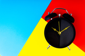 Clock on colorful background with selective focus and crop fragment. Copy space