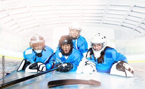 Fototapeta na szkło Hockey team laying on ice ring after the game