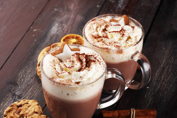 Hot chocolate cocoa with whipped cream on table.