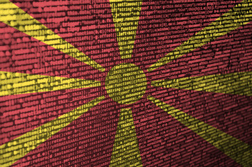 macedonia flag is depicted on the screen with the program code. the concept of modern technology and