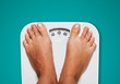 © BillionPhotos.com - Bare female feet standing on bathroom scale