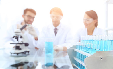 Wall Mural - background image of scientists studying blue liquid in a flask
