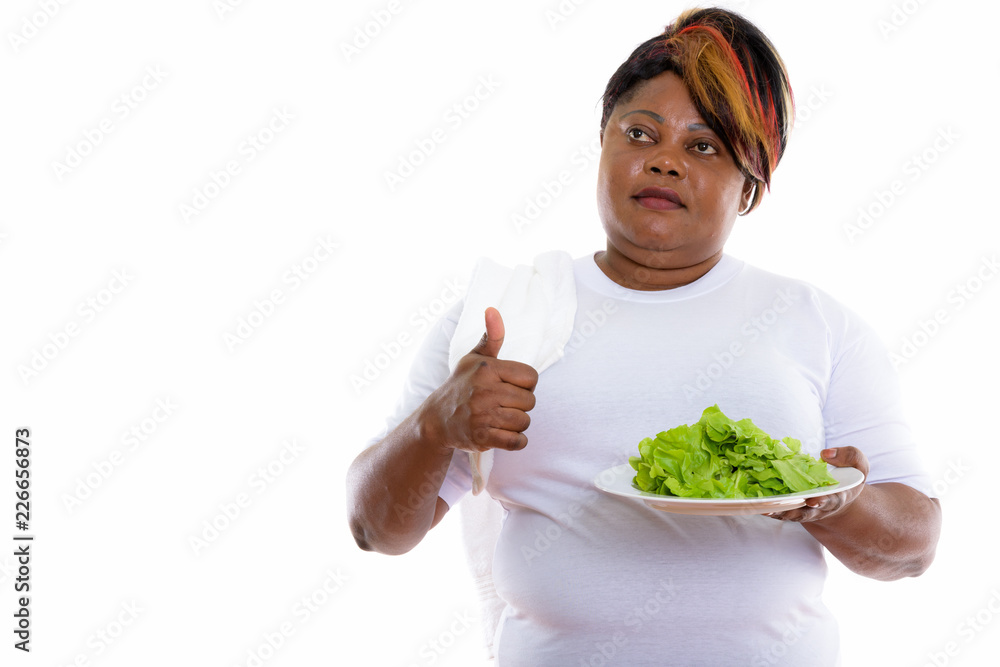 Studio shot of fat black African woman thinking and giving thumb Stock ...