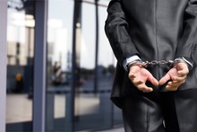Cropped Image Of Male Hands In Handcuffs