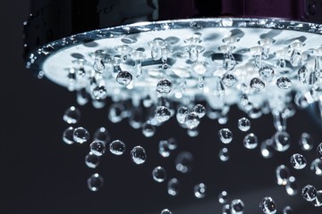 Poster - Shower Head with Water Stream on Black Background