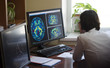 © Artem - A radiologist is working on a CT scan of a brain tumor