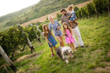 Wall Mural - Portrait of happy people spending time in vineyard