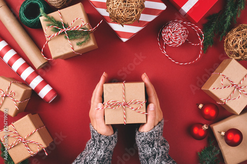 Christmas background with gift boxes, clews of rope, paper's rools and decora...