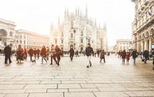 Blurred People Walking In Front Of Duomo Square In Milan - Defocused Crowd On Italian Metropolis Center