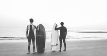 Young Surfers Waiting The Waves On The Beach - Sport Friends Getting Ready For Surfing - Extreme Sport, Youth Lifestyle And Recreation Concept - Black And White Editing