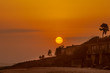 Bright orange sun setting over the beach of Cape Coast, Ghana